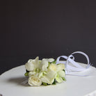 Our classic delicate fully wired wrist corsage features white spray roses and white dendrobium orchids with buds, accented with minimal greenery and ribbons. The wired design wraps securely around the wrist like a watch, ensuring it stays in place throughout your event. Ideal for weddings, formals, and special occasions. Available in a range of colors to complement your outfit or event theme.